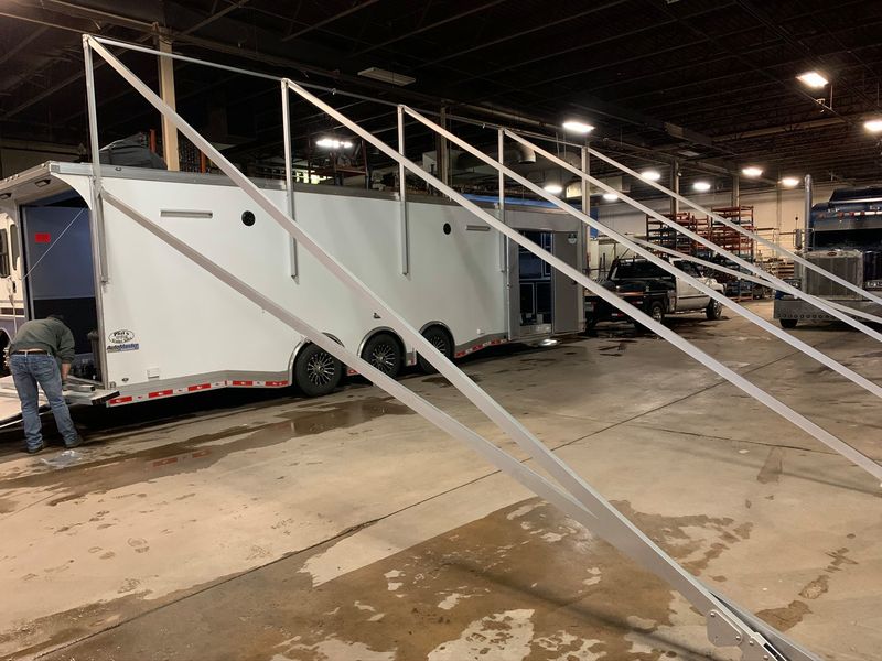 Aluminum A-frame awning supports installed on race trailers inside the DMP shop