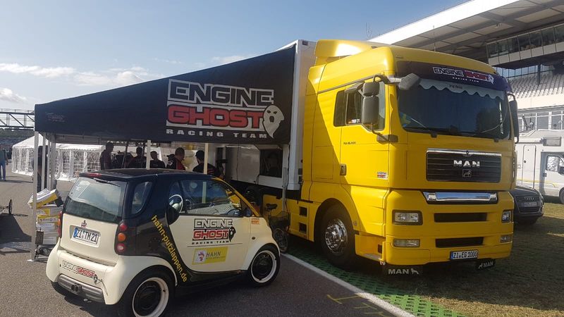 Engine Ghost Racing Team awning on a yellow MAN race truck in Germany