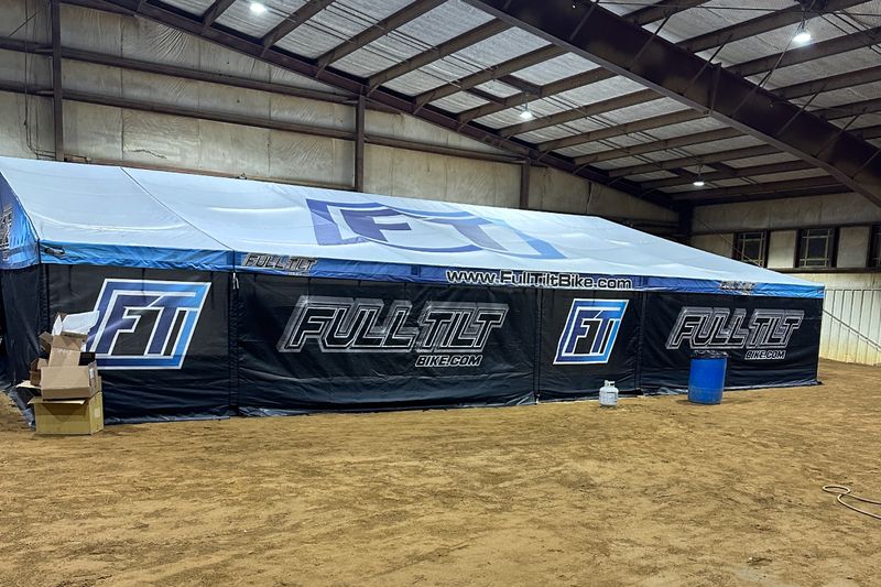 Full Tilt BMX racer support trailer with a fully enclosed DMP awning set up indoors