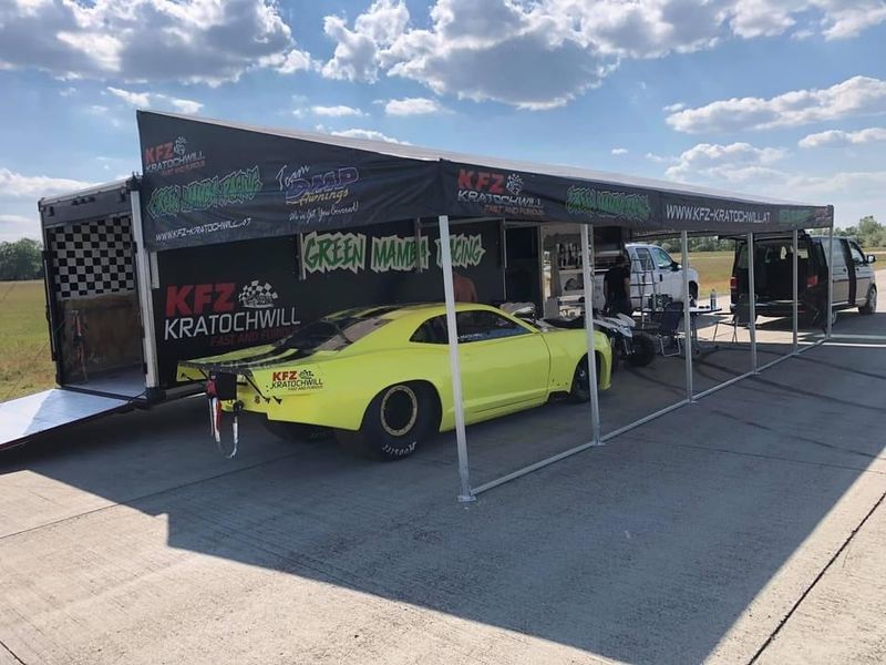 Green Mamba Racing trailer awning, shipped to Austria, with a lime green Camaro parked underneath