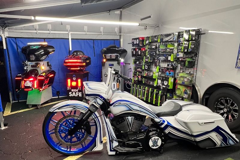 LED 4Ever motorcycle lighting display inside a DMP full enclosure, with a custom white bagger up front