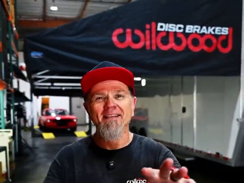 Mike from Wilwood Disc Brakes talking about the company's new DMP awning, printed with the red Wilwood logo