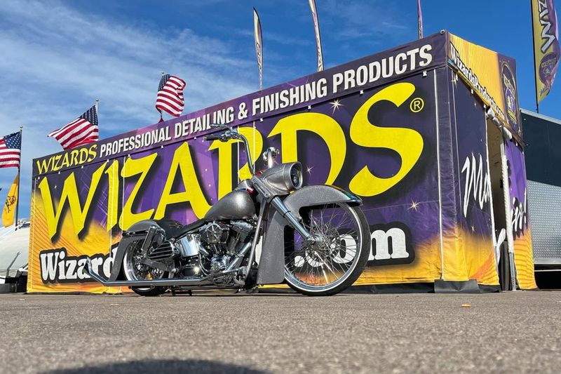 Wizards Products promotional trailer enclosure printed like a billboard, with a custom Harley parked in front
